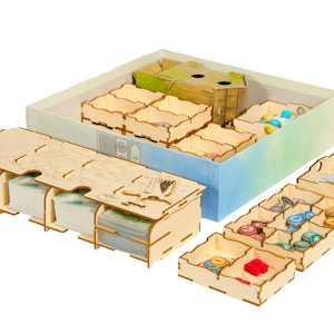 May include: Wooden organizer for a board game with multiple compartments for storing game pieces, cards, and tokens. The organizer is made of light brown wood and has a natural wood finish. The organizer is designed to fit inside a game box.
