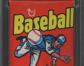 May include: A vintage 1975 Topps Baseball Wax Pack in a protective case. The pack features a red background with a yellow baseball graphic and a cartoon baseball player. The text "Baseball Trading Cards with 1 Stick Bubble Gum" is printed on the pack.