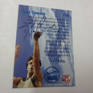 May include: A blue and white basketball trading card featuring Dave Cowens, a former NBA player. The card includes a photo of Cowens in action, his signature, and a brief biography. The card number is FP8 and the card is numbered 6/1050.