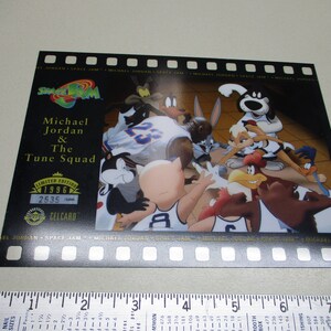 May include: A Space Jam trading card featuring Michael Jordan and the Tune Squad. The card is black with gold accents and features a photo of Michael Jordan and the Tune Squad characters playing basketball. The card is numbered 2535 and is a limited edition from 1996.