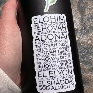 May include: A black water bottle with a white sticker featuring a list of names for God in Hebrew and English. The sticker includes the words "Elohim", "Jehovah", "Adonai", "El Elyon", and "El Shaddai".