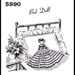 May include: Black and white line drawing of a bed doll pattern. The doll is wearing a dress with ruffles and is lying on a pillow with a ruffled edge. The pattern number 5990 and the words "Bed Doll" are printed above the image.