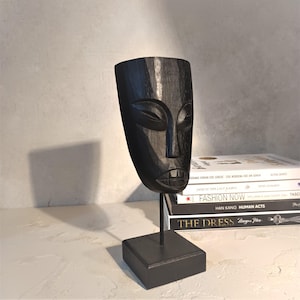 Hand-Carved Black Tribal Mask: Minimalist Wooden Sculpture on Stand