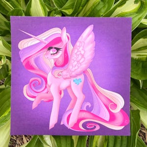 May include: A pink unicorn with a long, flowing mane and tail, and large, feathered wings. The unicorn has a blue heart-shaped mark on its flank and a long, spiraled horn. The artwork is set against a purple background.