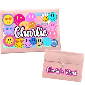 May include: Pink folder with a colorful smiley face design and the name "Charlie" printed on the front. The folder has a matching pink envelope with the text "Charlie's Mail" printed on the front.