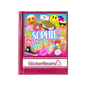 May include: A pink glitter notebook with a variety of colorful stickers, including a smiley face, a heart, a star, and the text "Sophie Live to 2". The notebook also has the text "StickerBeans" on the front.