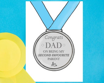 May include: A white card with a silver medal illustration. The medal has a blue ribbon and the text "Congrats Dad on being my second favourite parent".