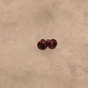 May include: Two red star-shaped screws with a silver finish.