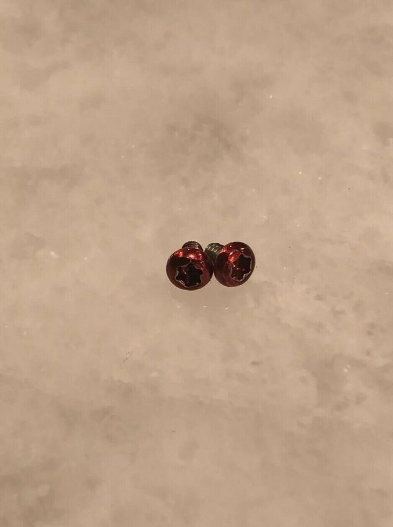 May include: Two red star-shaped screws with a silver finish.