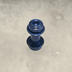 May include: A blue metal knob with a rounded top and a cylindrical base.