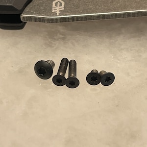 May include: Five black screws with a star-shaped head.