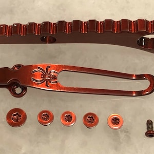 Può includere: Un set di ferramenta in metallo rosso per un coltellino tascabile. Il set include un fermaglio per tasca, un distanziatore posteriore e viti.