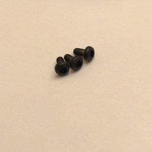 May include: Four black screws with a star-shaped head.