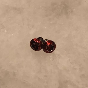 May include: Two red star-shaped screws with a silver finish.