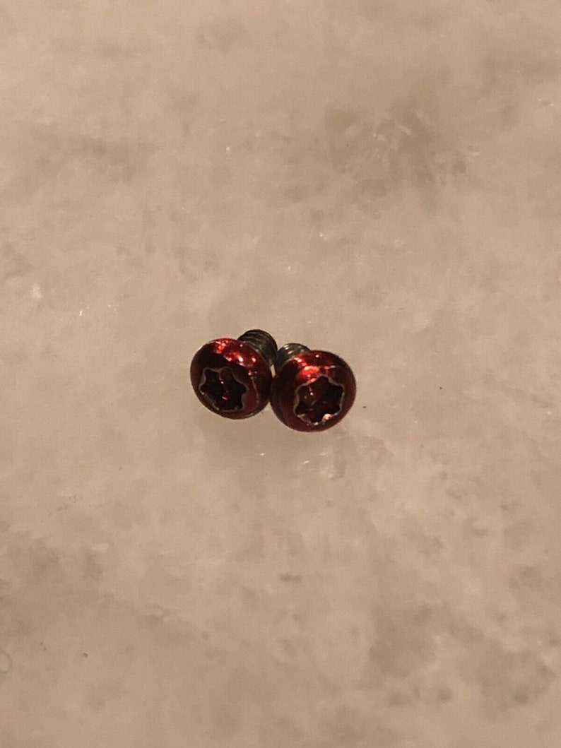 May include: Two red star-shaped screws with a silver finish.