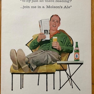 May include: A man relaxes in a yellow armchair with his feet up, holding a glass of beer and reading a magazine. The text on the ad reads "Why just sit there reading?...join me in a Molson's Ale." and "It's Canada's largest selling Ale."
