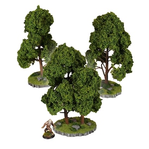 May include: Miniature model trees with green foliage and brown trunks, set on small, grassy bases. A small figurine of a Bigfoot-like creature is also present. Ideal for tabletop gaming or model train scenery.