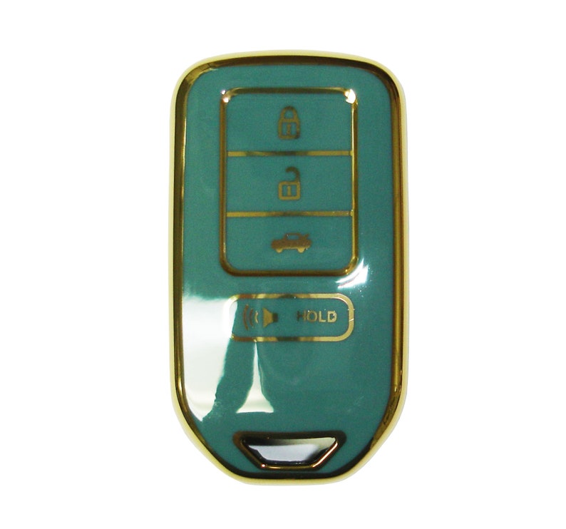 May include: A teal car key with gold trim and buttons. The buttons have symbols for lock, unlock, boot, and hold.