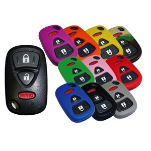 May include: Assortment of colorful silicone key covers for car key fobs. The covers are in various colors, including purple, orange, yellow, green, pink, red, blue, black, and gray. The covers have a button for unlock, lock, and panic.