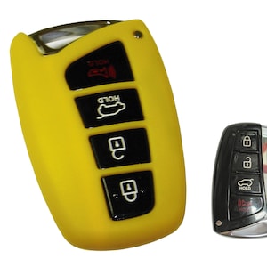 May include: A yellow silicone key fob cover for a car key. The key fob has five buttons, including a lock, unlock, trunk release, and panic button. The key fob cover has a HOLD button on the top and bottom.