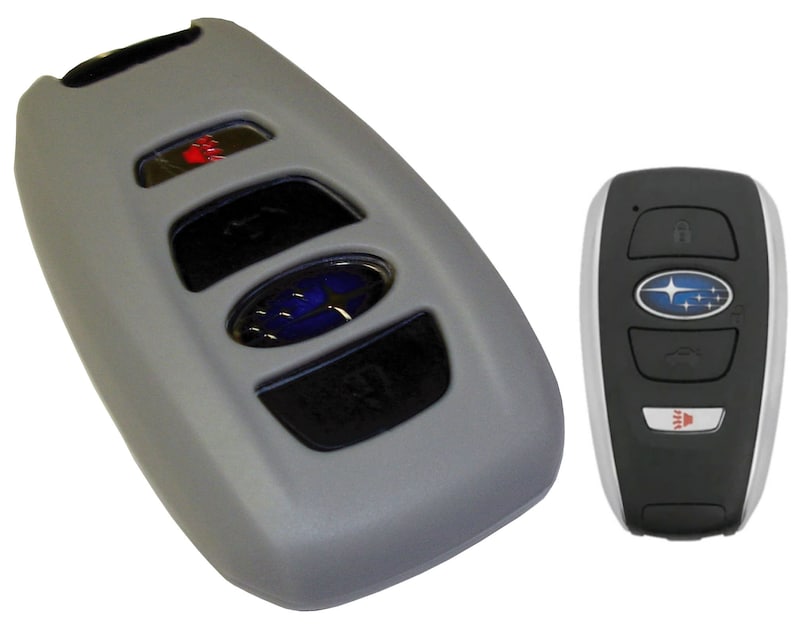 May include: Two gray car key fobs with a Subaru logo. The key fob on the left has four buttons and a red button. The key fob on the right has three buttons and a red button.