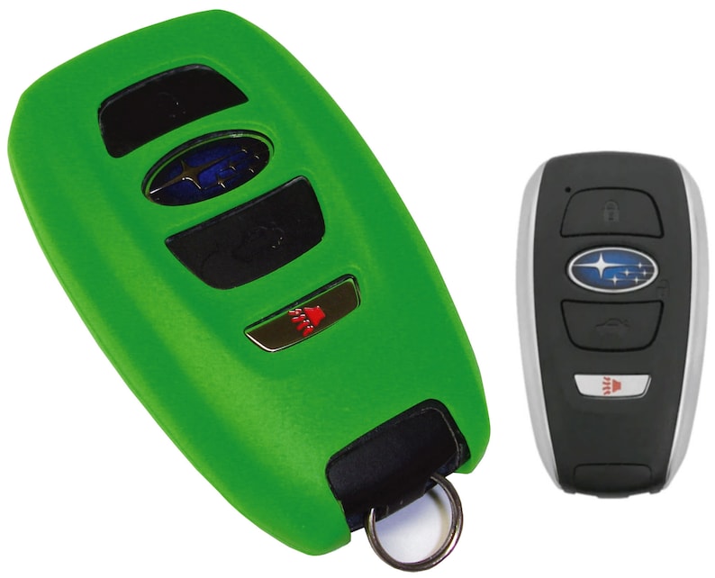 May include: A green silicone key fob cover for a Subaru car key. The key fob has four buttons and a Subaru logo. The key fob cover has a key ring attached.