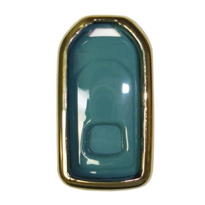 May include: A teal blue key fob case with a gold metal frame. The case has a clear plastic cover and a small button on the front.