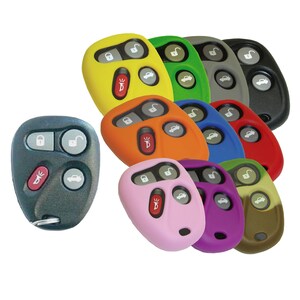 May include: A set of 10 colorful silicone key fob covers for car remotes. The covers are in various colors, including yellow, green, gray, black, orange, blue, red, pink, purple, and brown. The covers are designed to protect the remote from scratches and dirt.