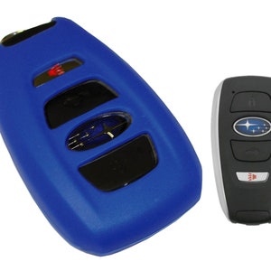 May include: A blue silicone key fob cover for a Subaru car key. The key fob has four buttons and a Subaru logo. The key fob is shown next to a silver and black car key.