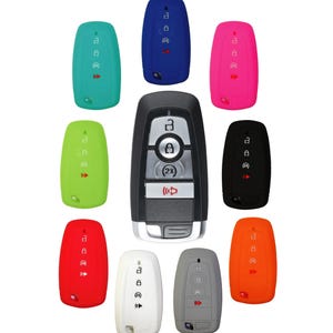 May include: A set of ten silicone key covers for car key fobs. The covers are in various colors, including blue, pink, green, black, red, orange, white, and gray. The key covers are designed to protect the car key fob from scratches and wear.