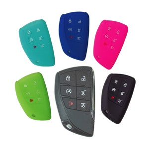 May include: Six silicone key covers in different colors: blue, green, pink, black, and gray. Each cover has a set of buttons with symbols for lock, unlock, and other functions.