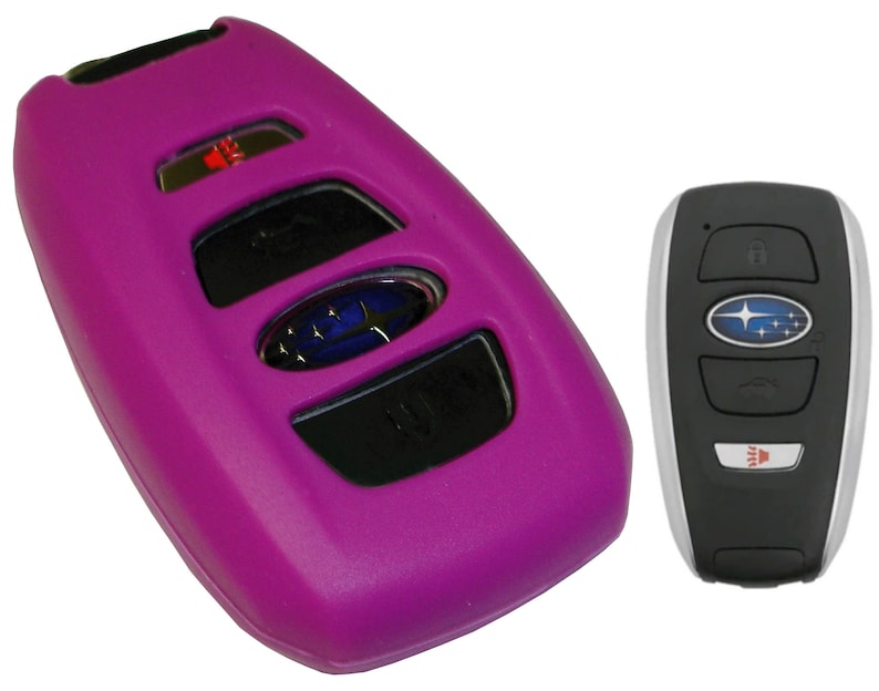 May include: A purple silicone key fob cover for a Subaru car key. The key fob has four buttons and a Subaru logo.