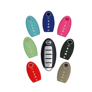 May include: A set of ten key covers for a Nissan car key. The covers are in various colors, including blue, pink, green, red, and black. The key covers are made of silicone and have a soft, rubbery feel. The key covers are designed to protect the car key from scratches and damage.