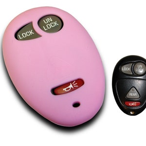 May include: Two car key fobs, one pink and one black. The pink fob has buttons labeled "Lock" and "Unlock" and a red button with a horn icon. The black fob has buttons labeled "Lock", "Unlock", and "Rear" and a red button with a horn icon.