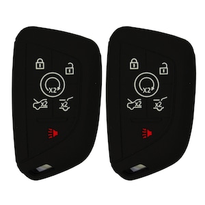 May include: Two black car key fobs with white icons. Each fob has a lock and unlock symbol, a circle with "x2" inside, and symbols for car functions. A red light icon is at the bottom.