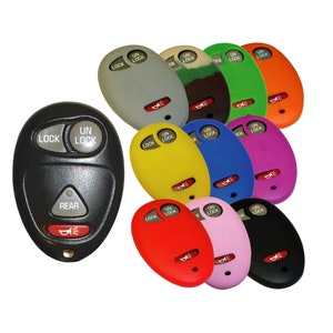 May include: A collection of ten key fobs in various colors, including black, gray, green, orange, yellow, blue, purple, red, pink, and white. Each fob has the words "LOCK" and "UN LOCK" printed on it, along with a small button labeled "REAR".