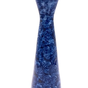 May include: A tall, slender vase with a flared top rim featuring a metallic gold edge. The body of the vase is decorated with a repeating pattern of swirling, circular brushstrokes in varying shades of deep navy and royal blue throughout.