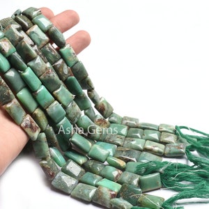 May include: A strand of green and brown chrysoprase beads, each bead is rectangular and has a polished finish. The beads are strung on a green cord with green tassels at the end.