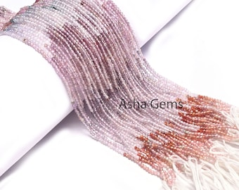May include: A strand of pink, purple, and red gemstone beads. The beads are faceted and have a slightly irregular shape. The strand is approximately 16 inches long and is strung on a white thread.