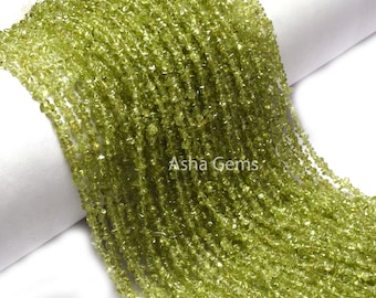 May include: A strand of green peridot gemstone beads. The beads are small and irregular in shape, giving the strand a natural, rustic look.