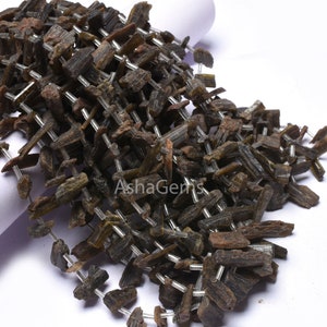 May include: A strand of dark green and brown gemstone beads, strung on silver wire. The beads are irregular in shape and have a rough, natural texture.