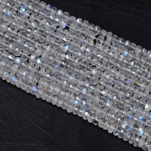 May include: A strand of white moonstone beads with a faceted, square shape. The beads have a subtle iridescent shimmer.