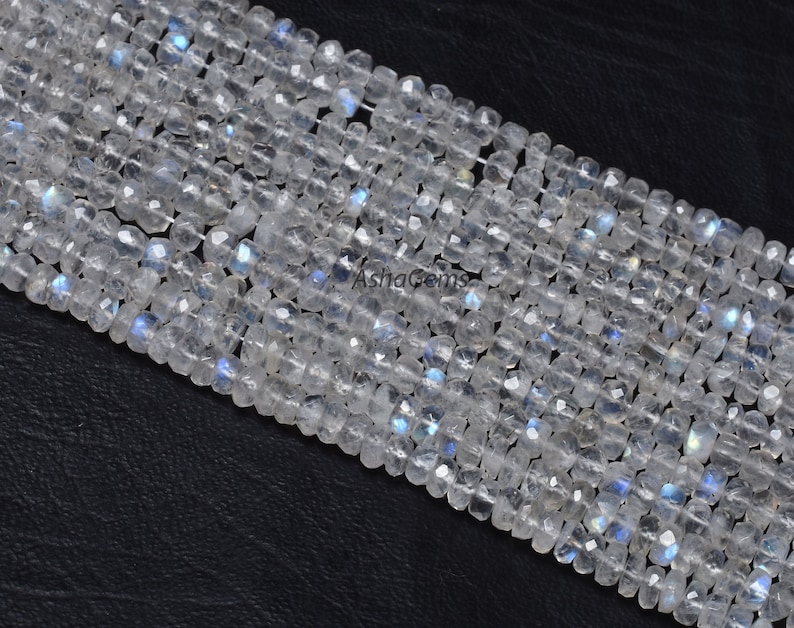 May include: A strand of white moonstone beads with a faceted, square shape. The beads have a subtle iridescent shimmer.