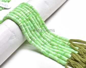 May include: A strand of light green gemstone beads, with a tassel at the end of each strand. The beads are small and round, and the strands are arranged in a fan shape. The text "Asha Gems" is visible on the white background.