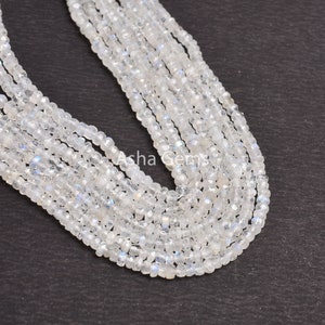 May include: A strand of white moonstone beads, approximately 4mm in size, with a slight iridescent shimmer. The beads are strung on a clear thread and are arranged in a loose, flowing pattern.