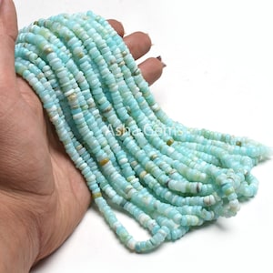 May include: A strand of light blue opal beads, approximately 4mm in size. The beads are smooth and have a slightly iridescent finish.