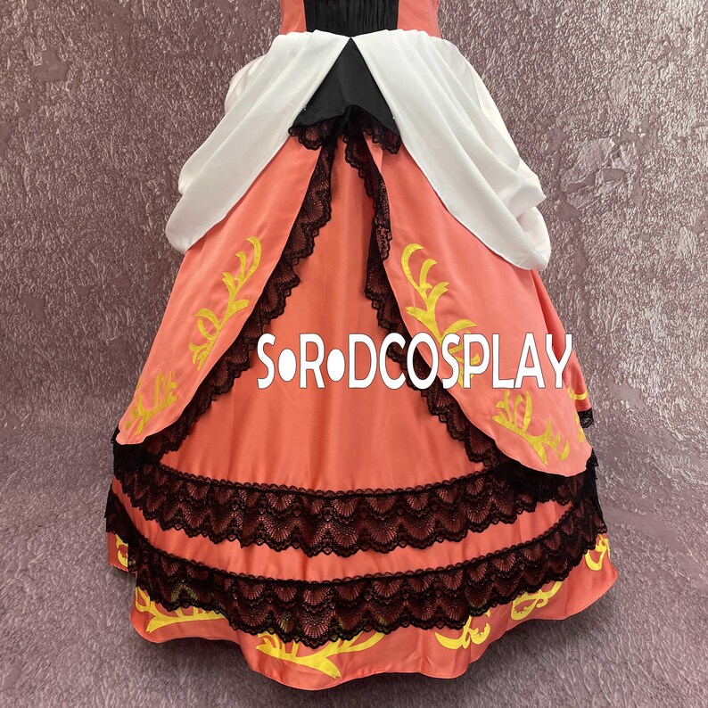 May include: A coral-colored dress with black lace trim and yellow embroidered accents. The dress features a white and black bodice and the text "S O R DCOSPLAY".
