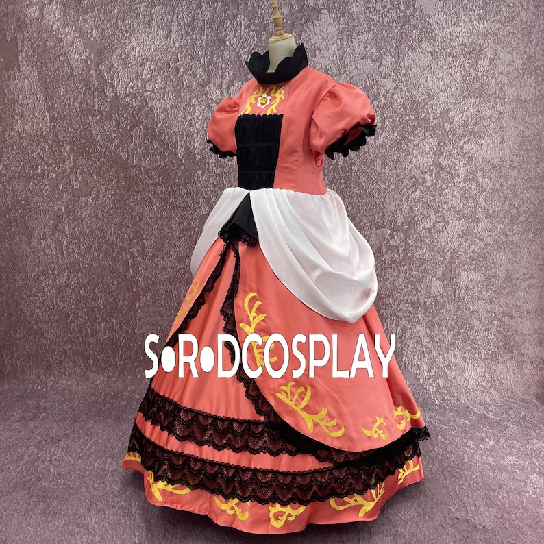 May include: A coral-colored cosplay dress with black lace trim and gold embroidery. The dress features a black bodice, white accents, and puffed sleeves. The text "S OR DCOSPLAY" is visible on the skirt.
