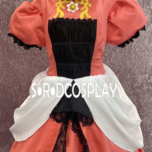 May include: A coral-colored cosplay dress with black and white accents. The bodice features a black panel with lace trim and a decorative yellow design. The dress has puffed sleeves and a full skirt. The text "SORODCOSPLAY" is visible.
