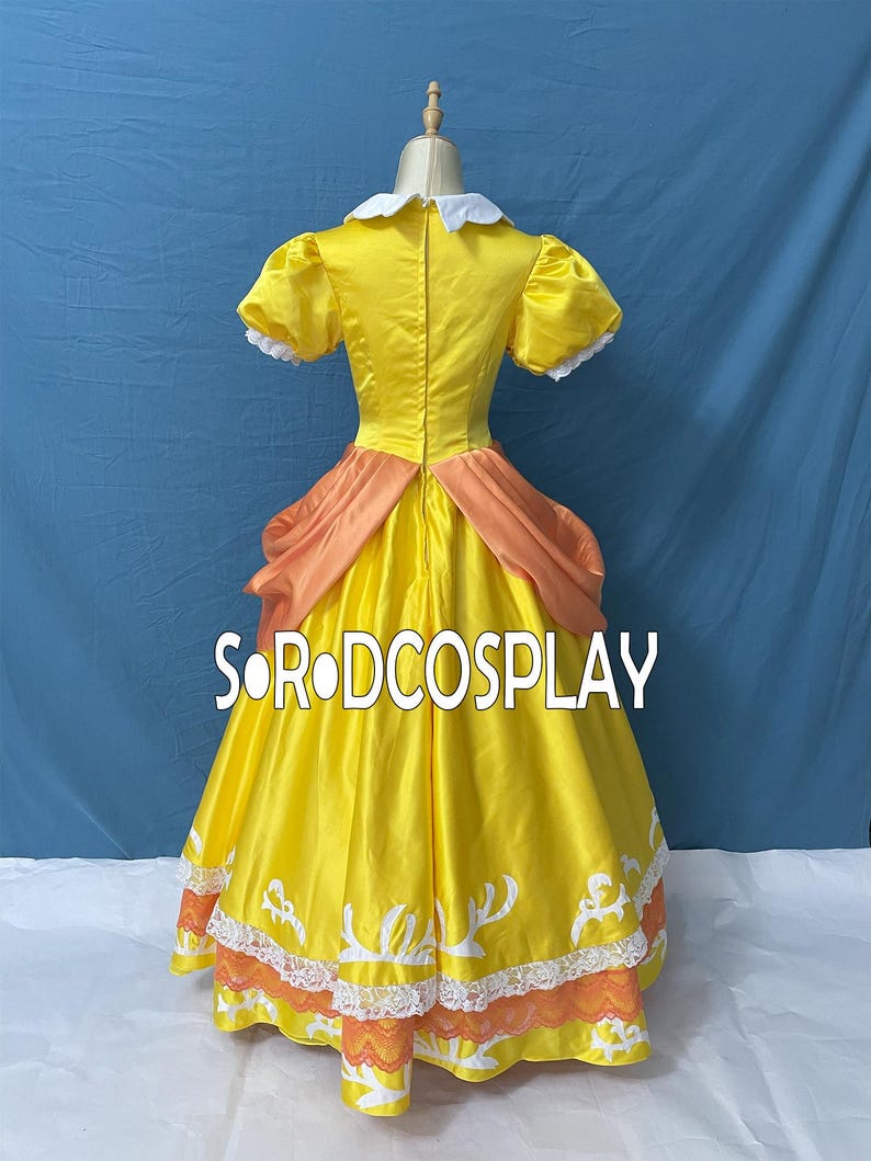May include: A yellow cosplay dress with a white collar and puff sleeves. The dress features orange accents at the waist and hem, with white and orange lace trim. The text "SORODCOSPLAY" is visible on the dress.